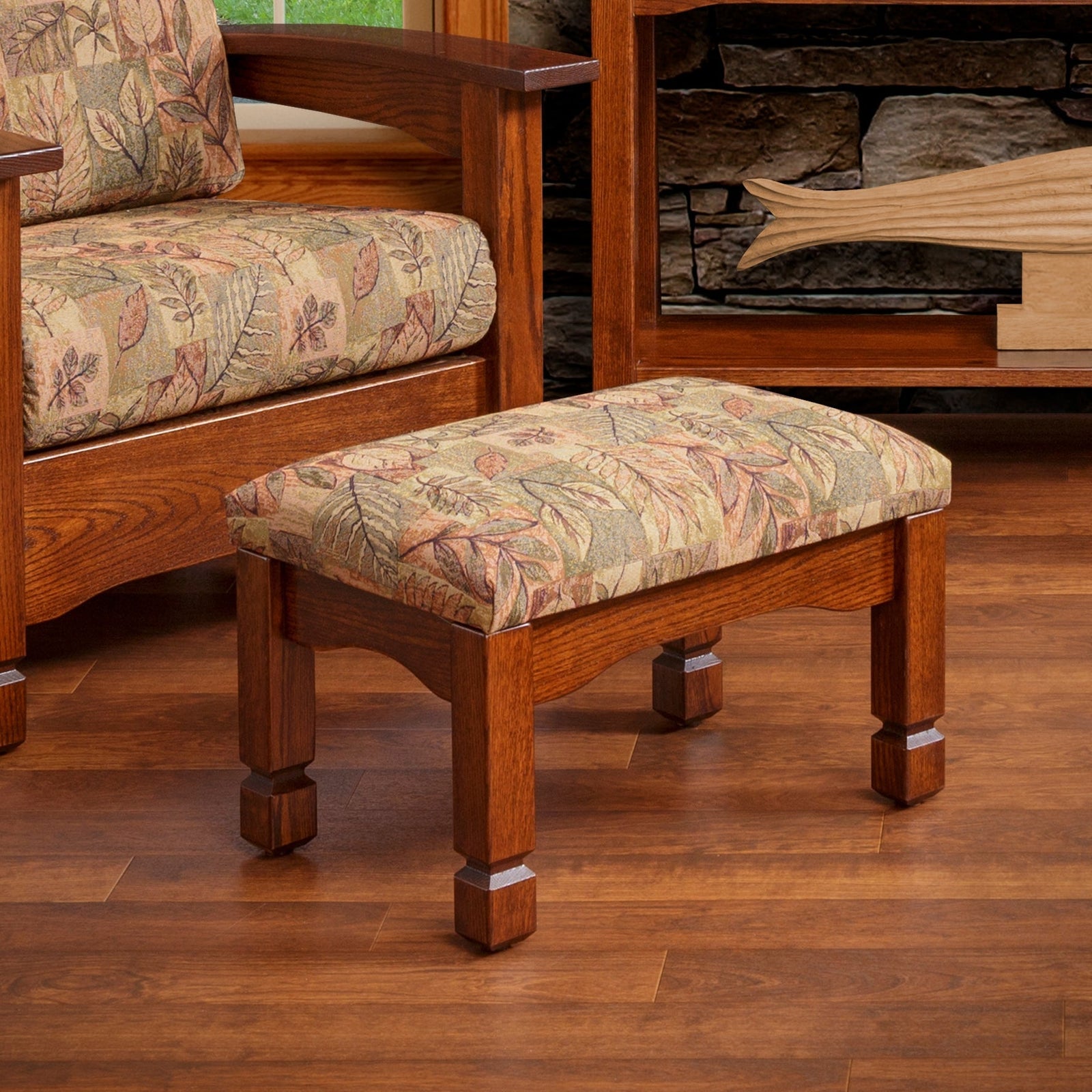 Mission oak ottoman with a brown leather cushioned top, paneled sides and square block feet