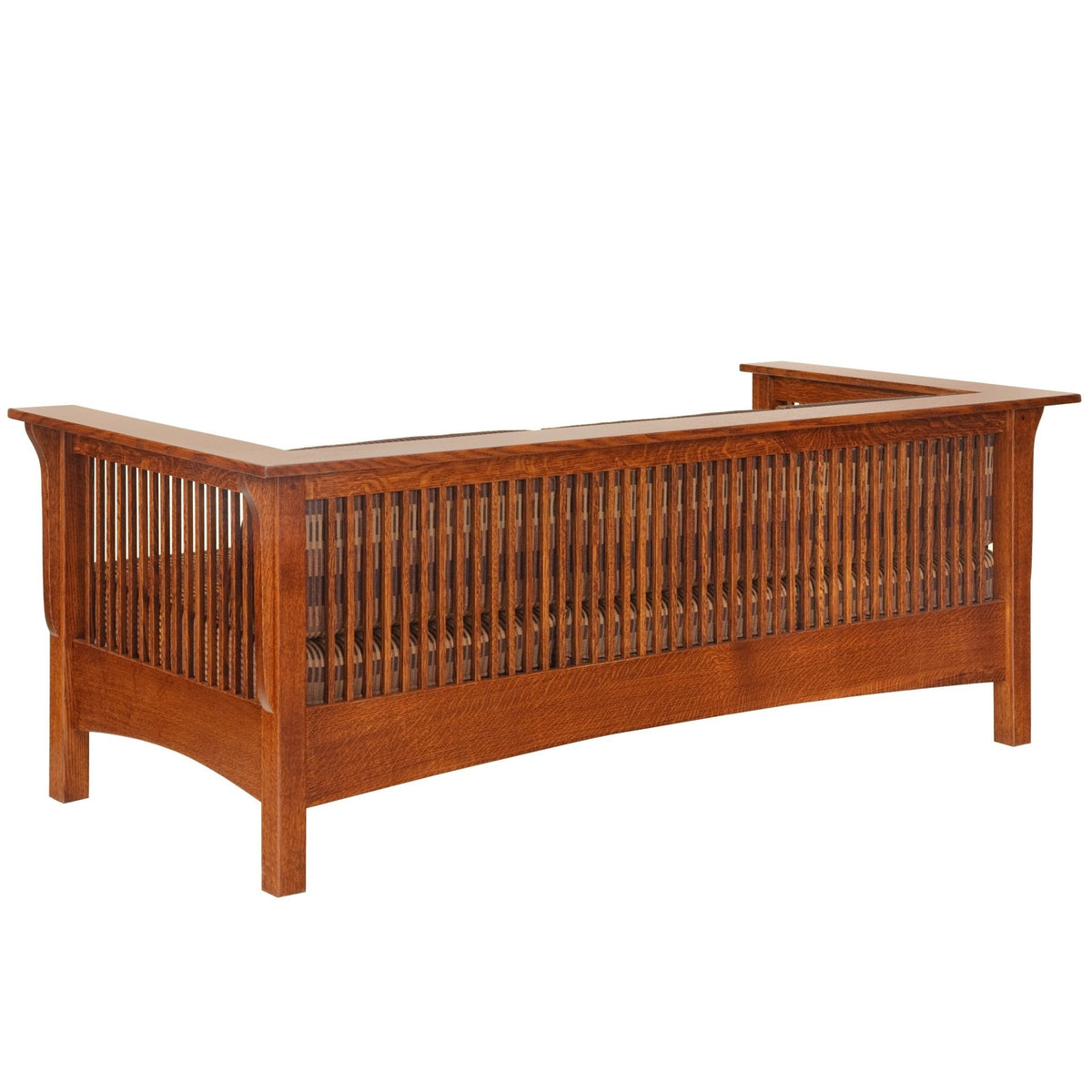 Rear view of a Mission oak slat side sofa showing rows of vertical back spindles and an arched lower rail