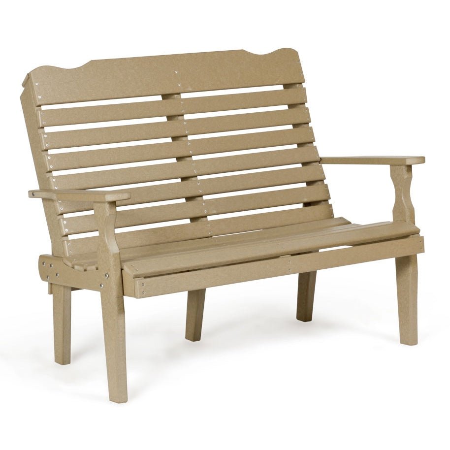 White poly curved back 4 foot patio bench with horizontal slats and contoured arms on a paver patio by a stone wall
