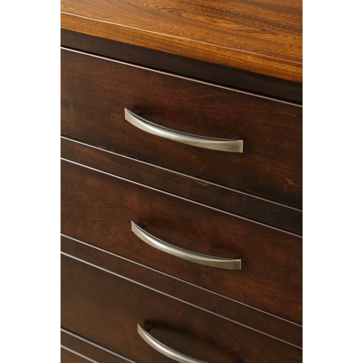 Close-up of the server's brushed nickel arched pulls, espresso drawer fronts and the oak top edge
