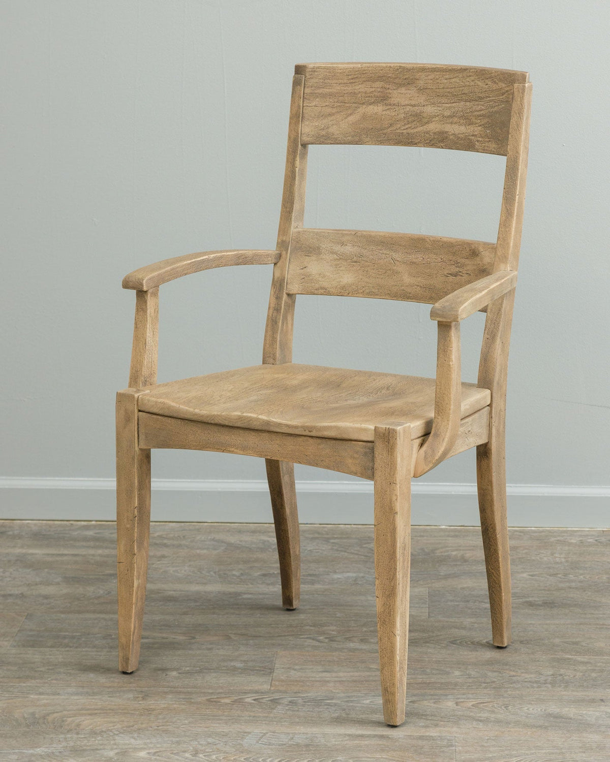 Rustic driftwood toned dining arm chair with a plank slat back, sculpted seat and tapered square legs