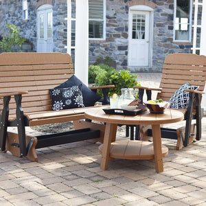 Cedar and black poly double glider bench with round coffee table and glider chair set on a brick paver patio