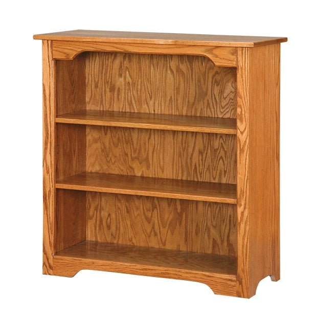 Solid oak 36 inch bookcase with two adjustable shelves in a warm honey stain and shaped base