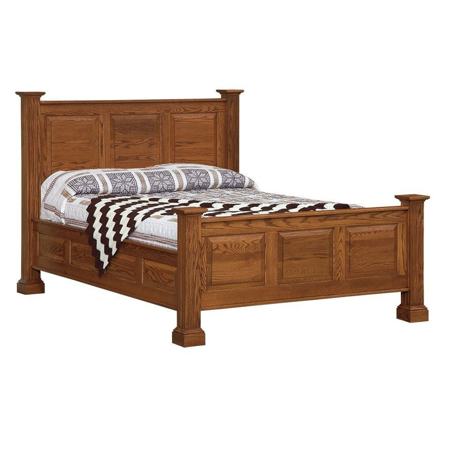 Oak raised panel bed with square capped posts and a three-panel headboard, dressed in a woven throw