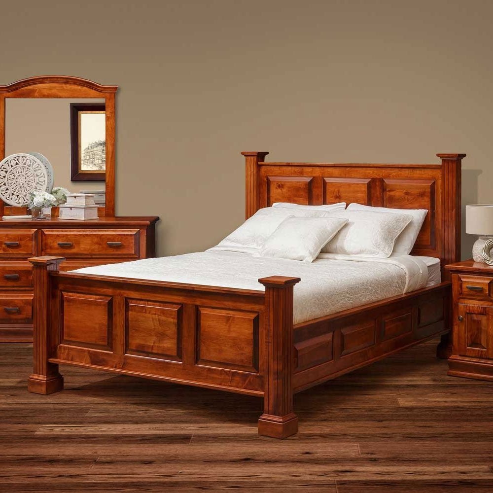 Cherry finished panel bed with block posts, mirrored dresser and nightstand in a warm styled bedroom