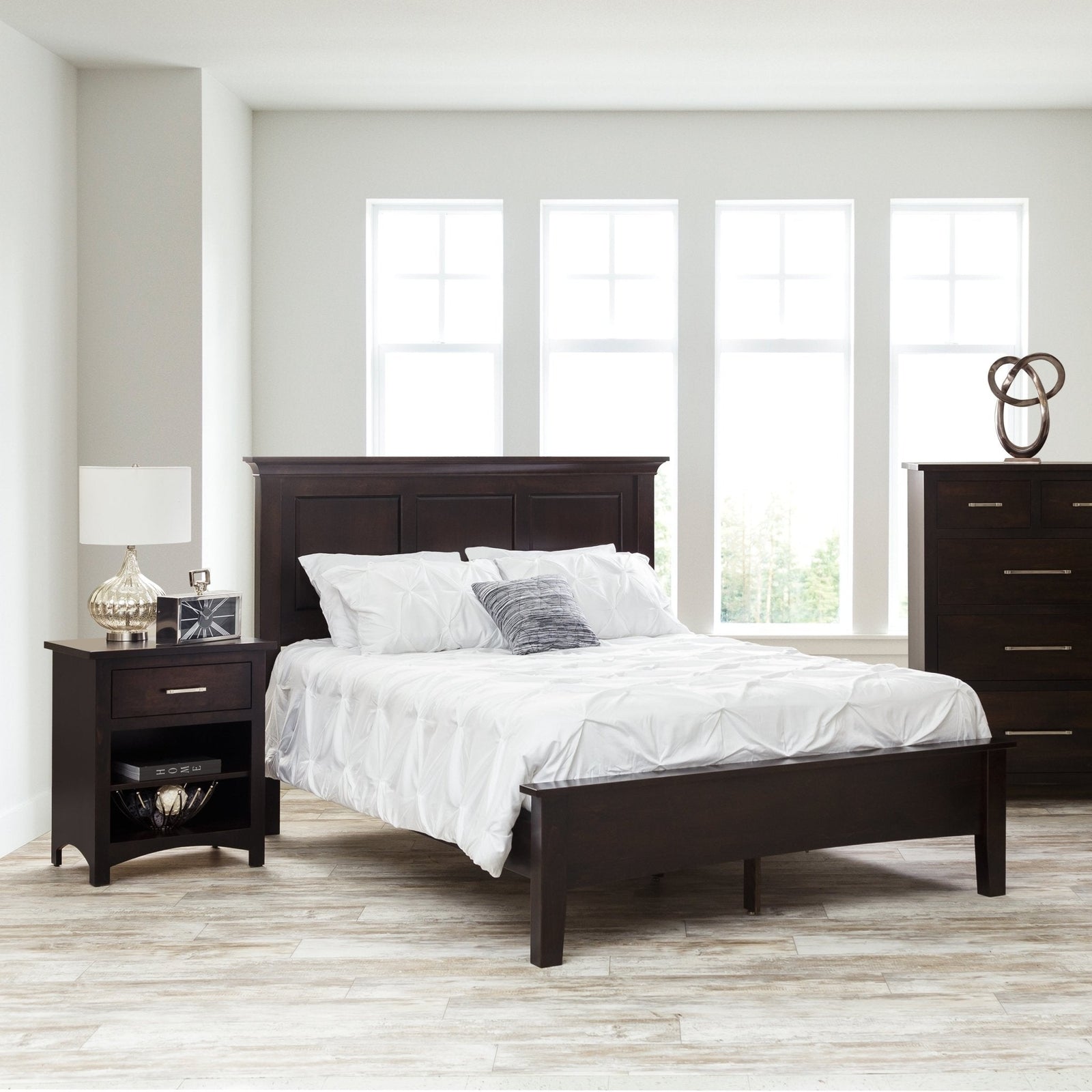 Espresso panel bed with a raised three-panel headboard and low footboard, white bedding and open nightstand