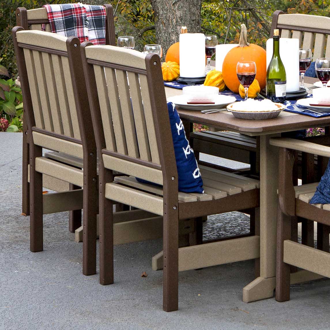 Weatherwood and brown poly side dining chairs without arms around a fall patio table with pumpkins and pie