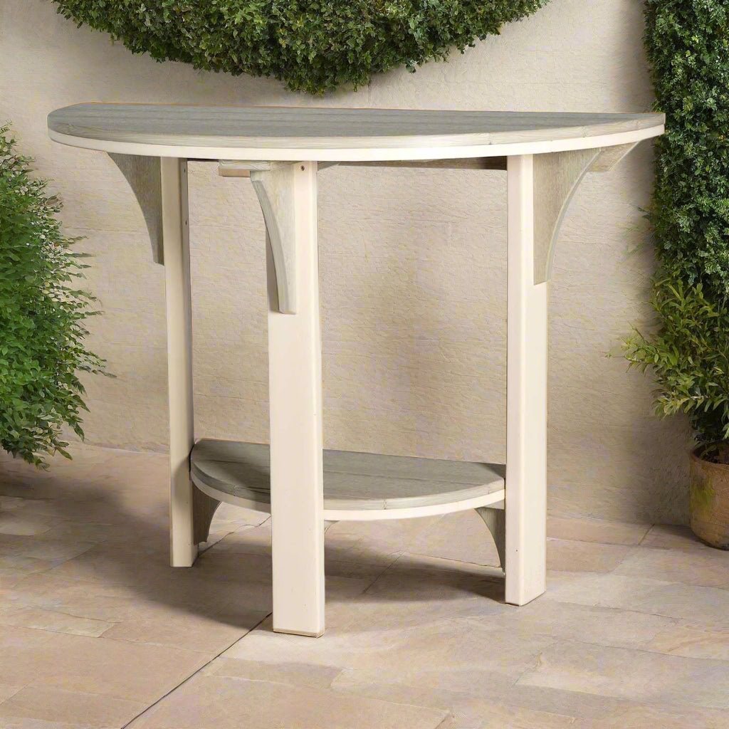 Weatherwood poly half round counter table with two saddle seat stools on a deck above a coastal marsh