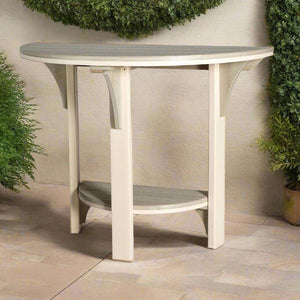 Half round poly patio table in ivory with a weathered gray top and lower shelf against a stucco wall