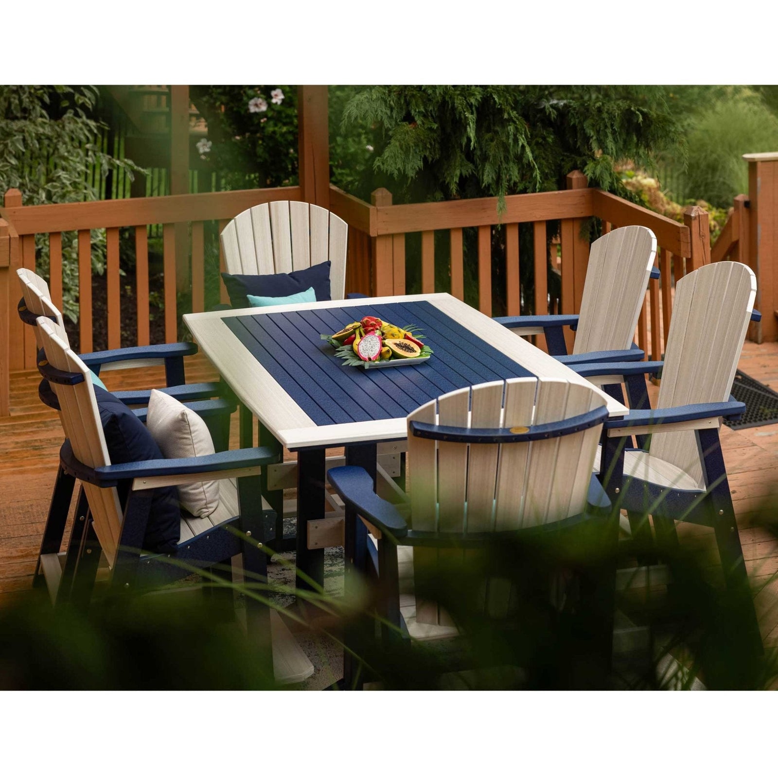 Navy and white poly counter height patio table with six fan back chairs on a deck by a wood sided cabin