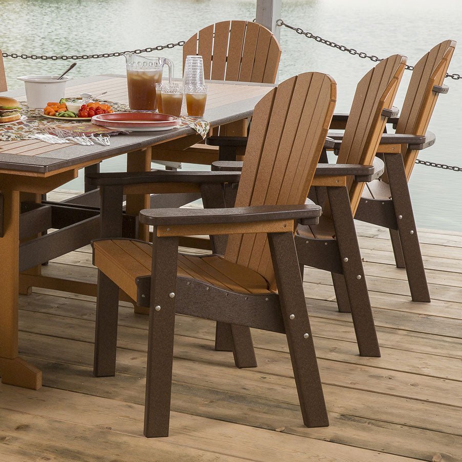 Row of cedar and brown poly Adirondack dining chairs with fan backs at a lakeside dock table