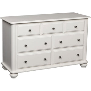 White painted seven drawer dresser with recessed drawer fronts, dark round knobs and turned bun feet