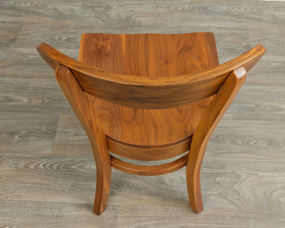 Overhead rear view of the walnut dining chair highlighting the contoured saddle seat and flared back posts