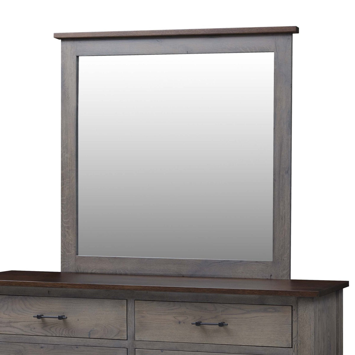 Rectangular bedroom mirror in a gray oak frame with a dark brown top cap, resting on the matching six drawer dresser