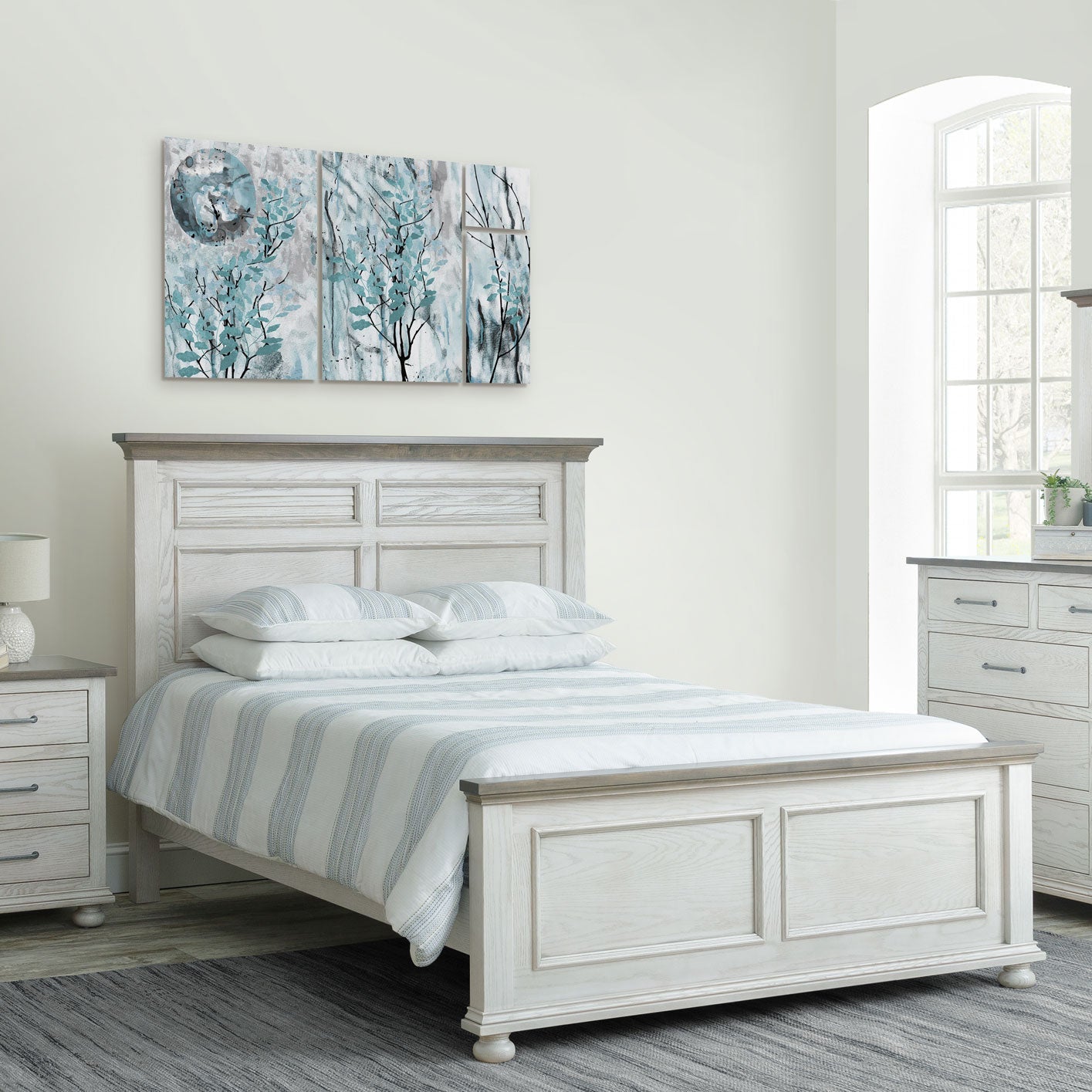 Coastal white bedroom set with panel bed, nightstand, armoire and mirrored dresser on a gray area rug