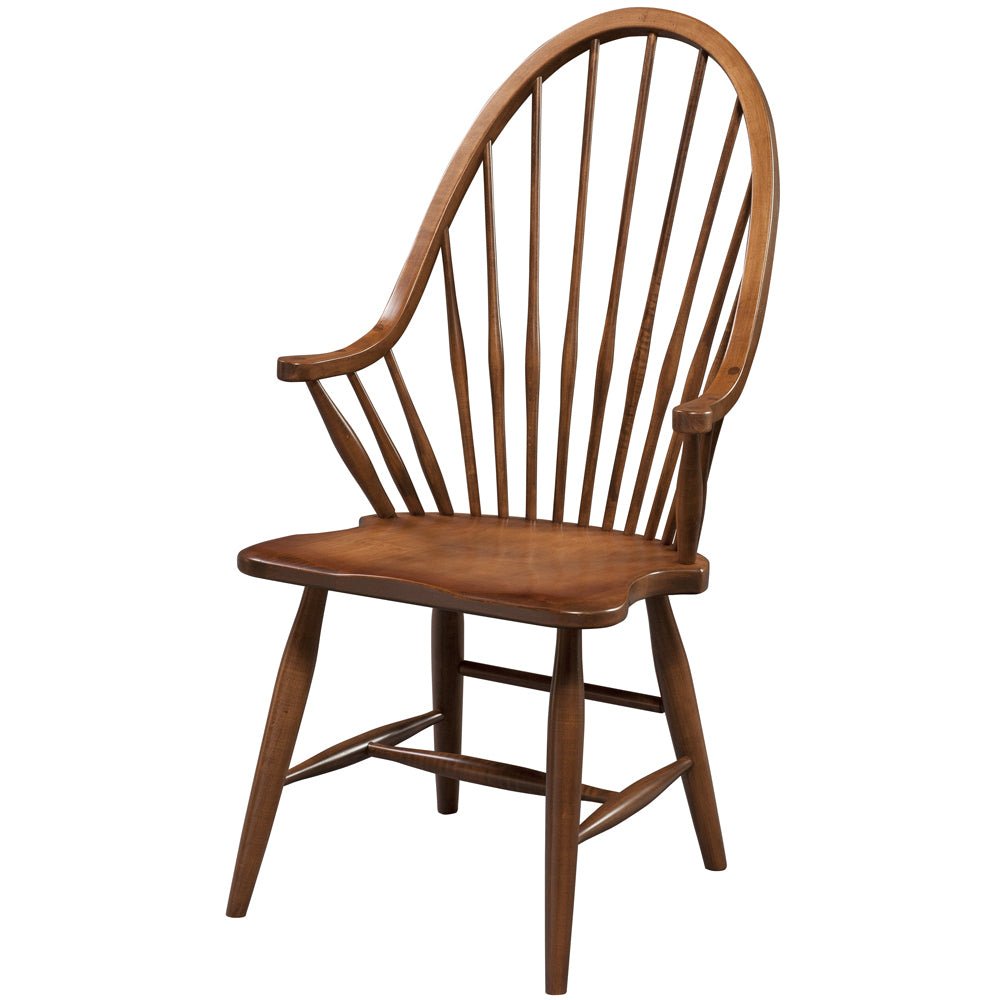 Solid maple Windsor arm chair in a medium brown finish with continuous arm bow, shaped seat and splayed legs on white