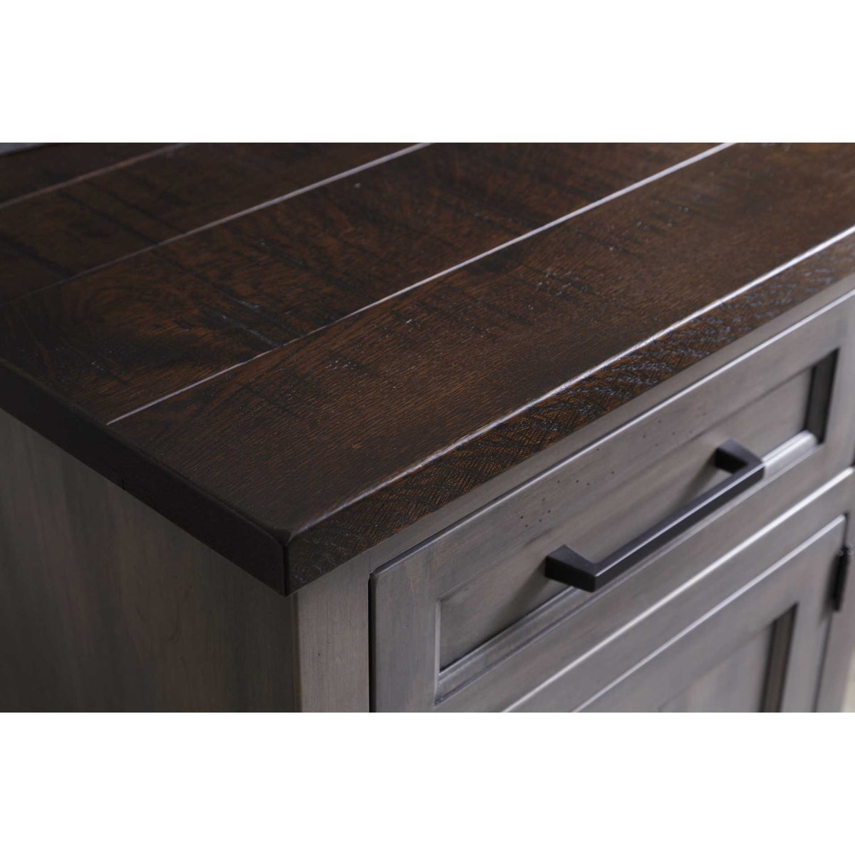 Close-up of the nightstand's rough-sawn dark brown plank top over a gray drawer front with matte black pull
