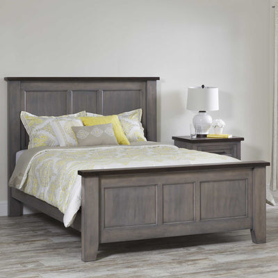 Gray solid wood queen panel bed with a dark stained top rail, styled with yellow paisley bedding beside a matching two-tone nightstand
