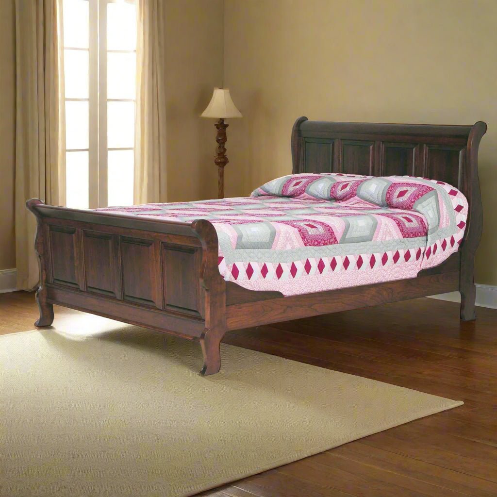 Espresso-stained sleigh bed with paneled headboard and curved footboard in a sunlit room with a floor lamp