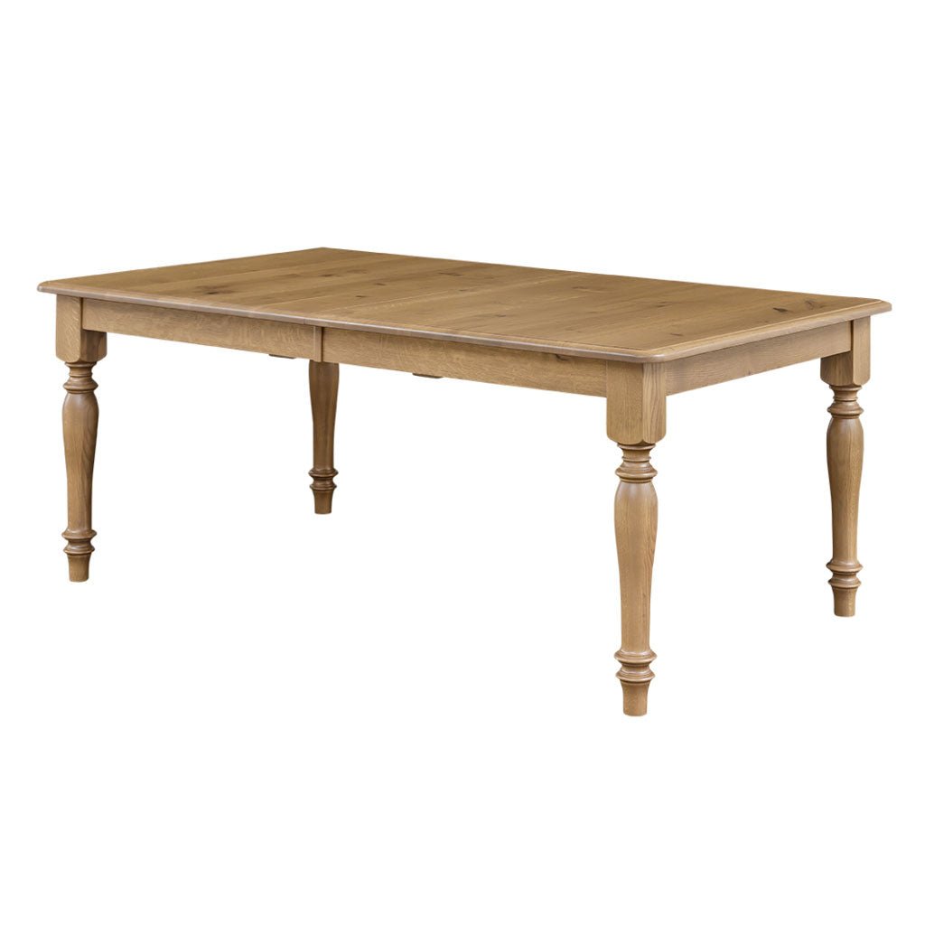 Extendable rectangular dining table in light quartersawn oak with turned farmhouse legs, viewed at an angle on a white background