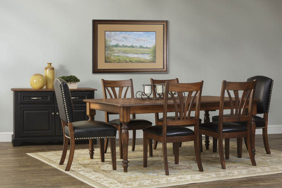 Traditional dining room set with a brown maple turned-leg table, splat-back wood chairs and black leather nailhead host chairs beside a black sideboard