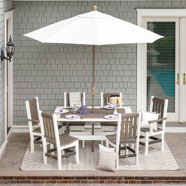 White and driftwood poly rectangular dining table with six slat back chairs under a white market umbrella