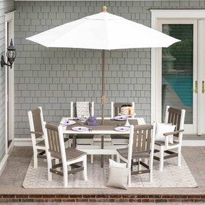 White and driftwood poly rectangular dining table with six slat back chairs under a white market umbrella