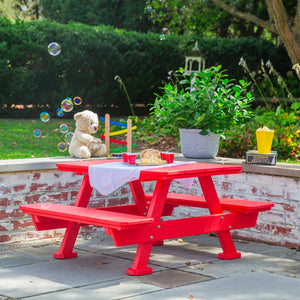 Red poly kids picnic table with attached benches set with popcorn and cups on a patio with bubbles and a teddy bear