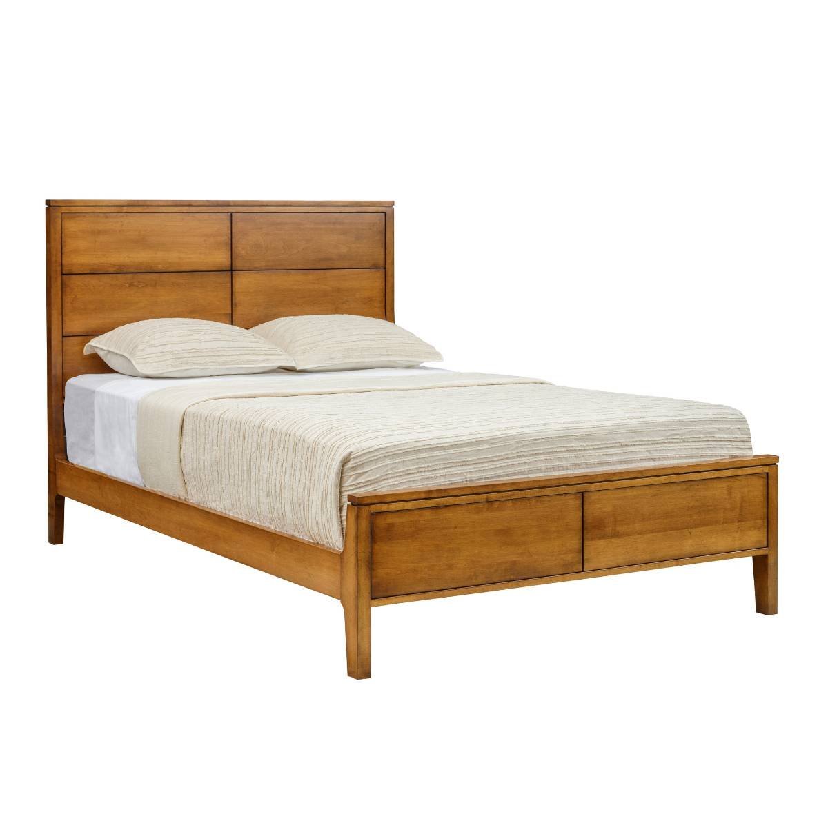 Mid century maple panel bed with a six-panel headboard, low paneled footboard and tapered legs on white