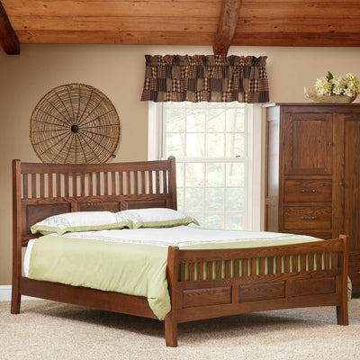 Mission slat bed in warm oak with a curved slat headboard and matching footboard in a beamed bedroom