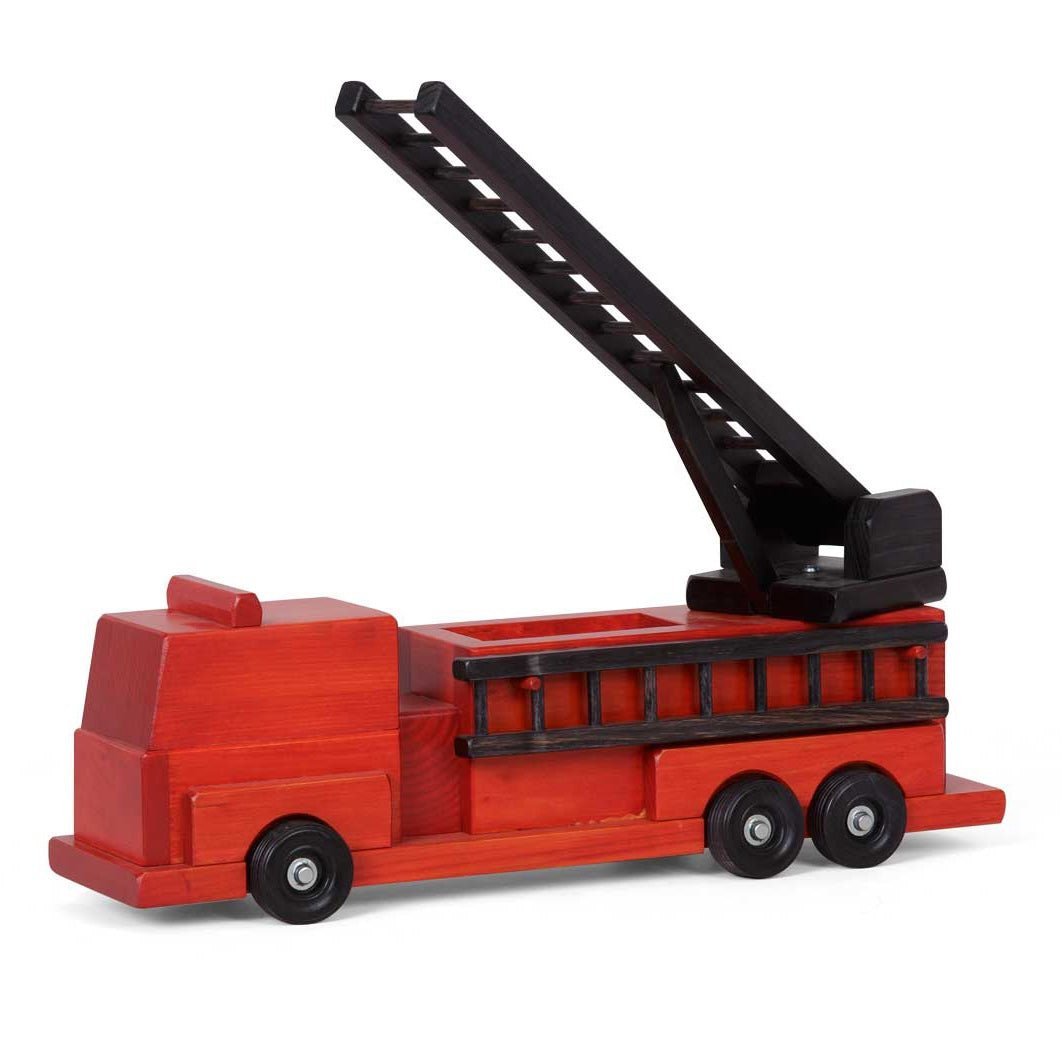 Toddler and adult playing on a rug with a red wooden fire truck toy, raising its long black extension ladder