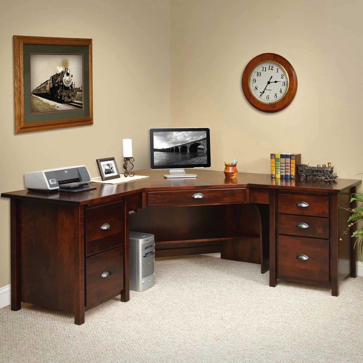L shaped corner desk in dark cherry with center drawer, two and three drawer pedestals and a computer tower cubby