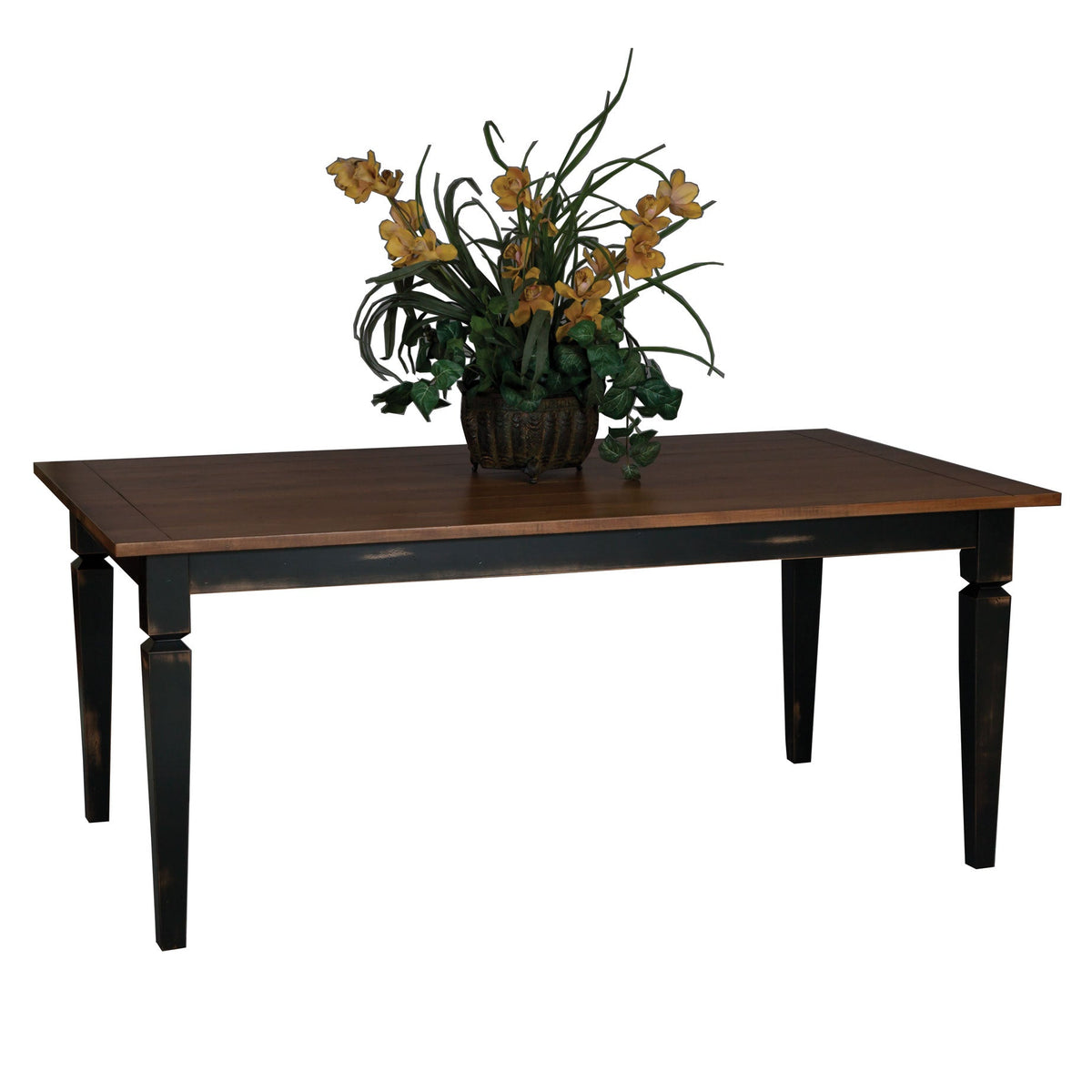 Rectangular dining table with a breadboard oak top and distressed black tapered legs, floral centerpiece on top