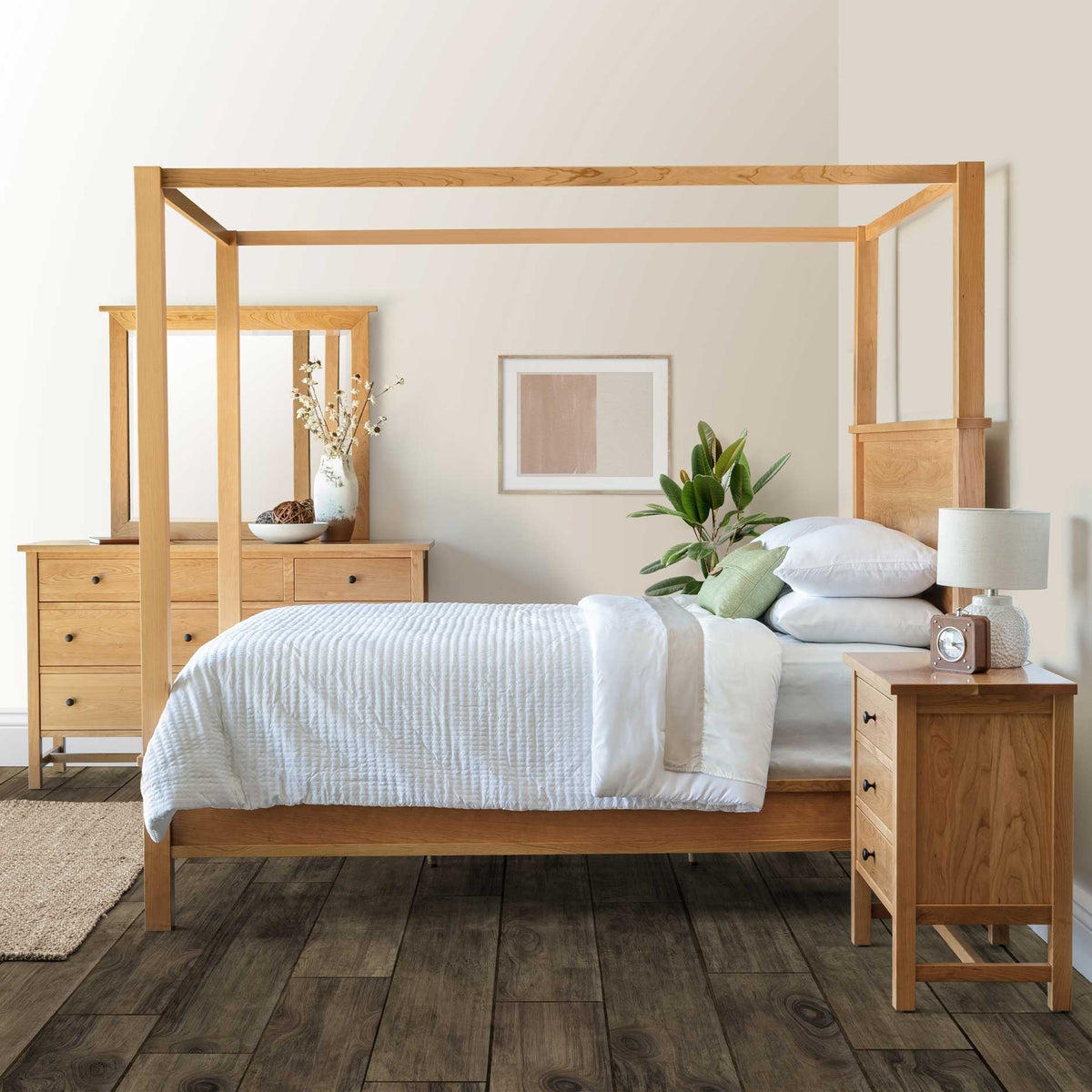 Cherry bedroom set with a canopy bed, seven-drawer dresser with mirror and three-drawer nightstand on gray wood flooring