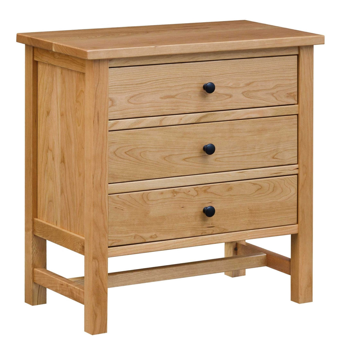 Cherry three-drawer nightstand with black round knobs, recessed side panels and a base stretcher on a white background