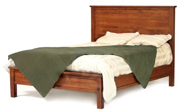 Cherry panel bed with a wide flat headboard, low footboard and green throw over cream bedding