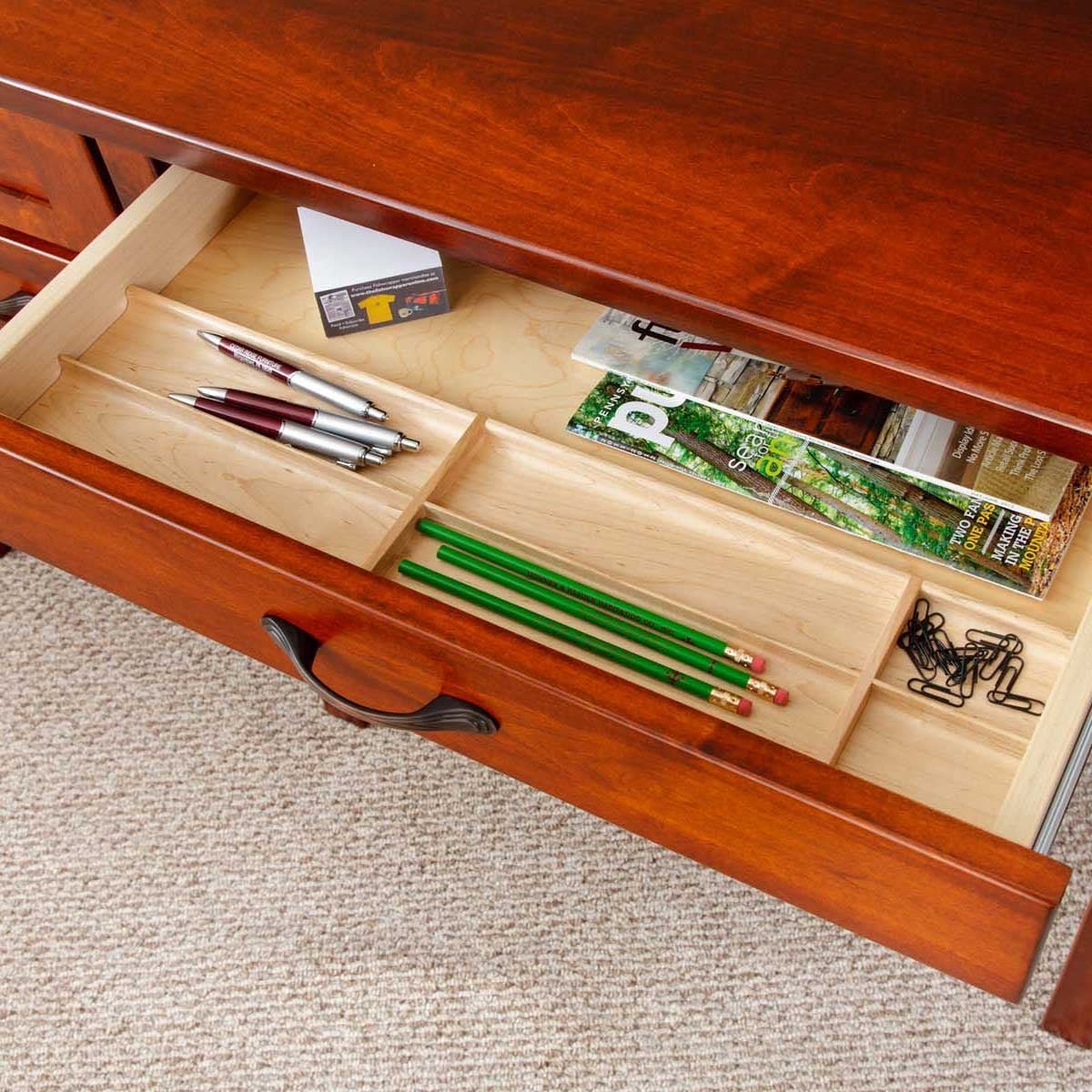 Open center pencil drawer with maple compartment tray for pens, pencils and clips in a cherry office desk