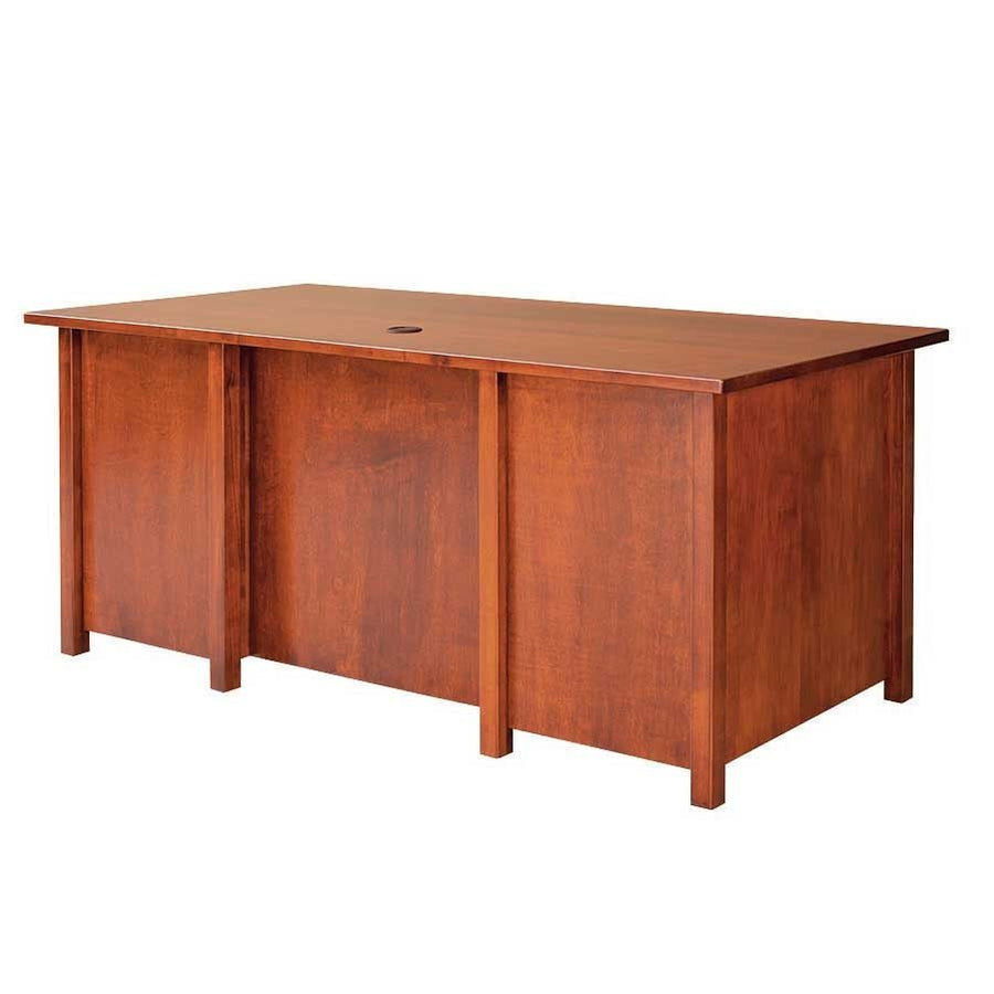 Back view of a solid wood executive desk in a cherry finish with flat panel modesty back, square legs and a top grommet hole