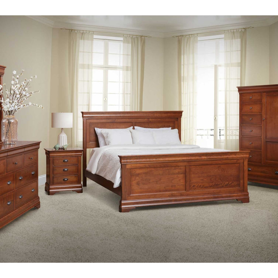Cherry panel bed styled in a bright bedroom with a nightstand, dresser and tall door chest on carpet