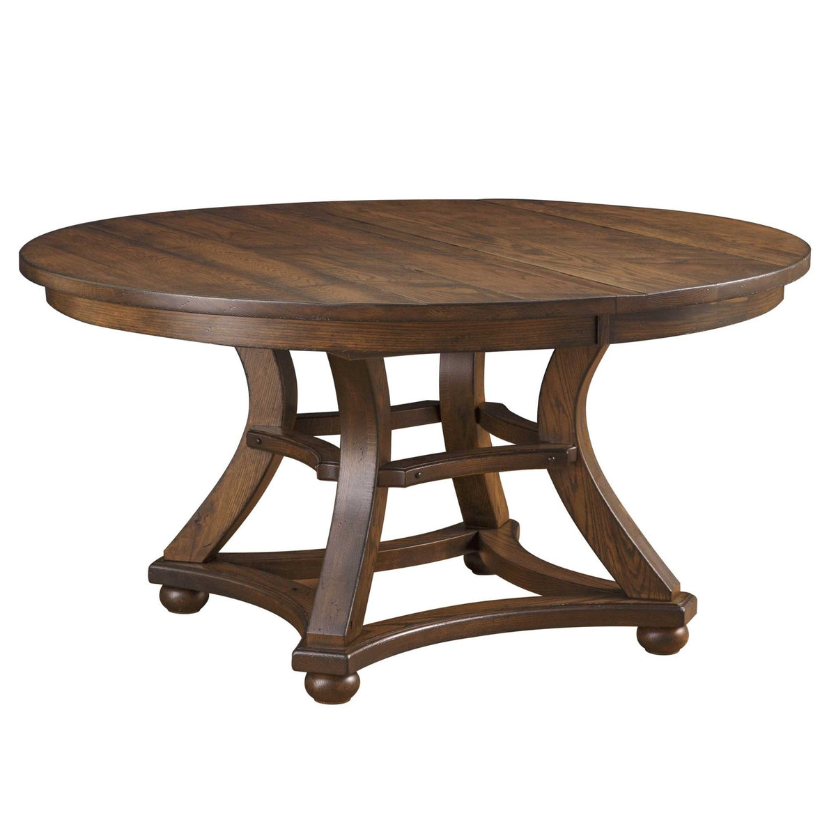 Round pedestal dining table with a plank top, arched trestle-style base and bun feet on a white background