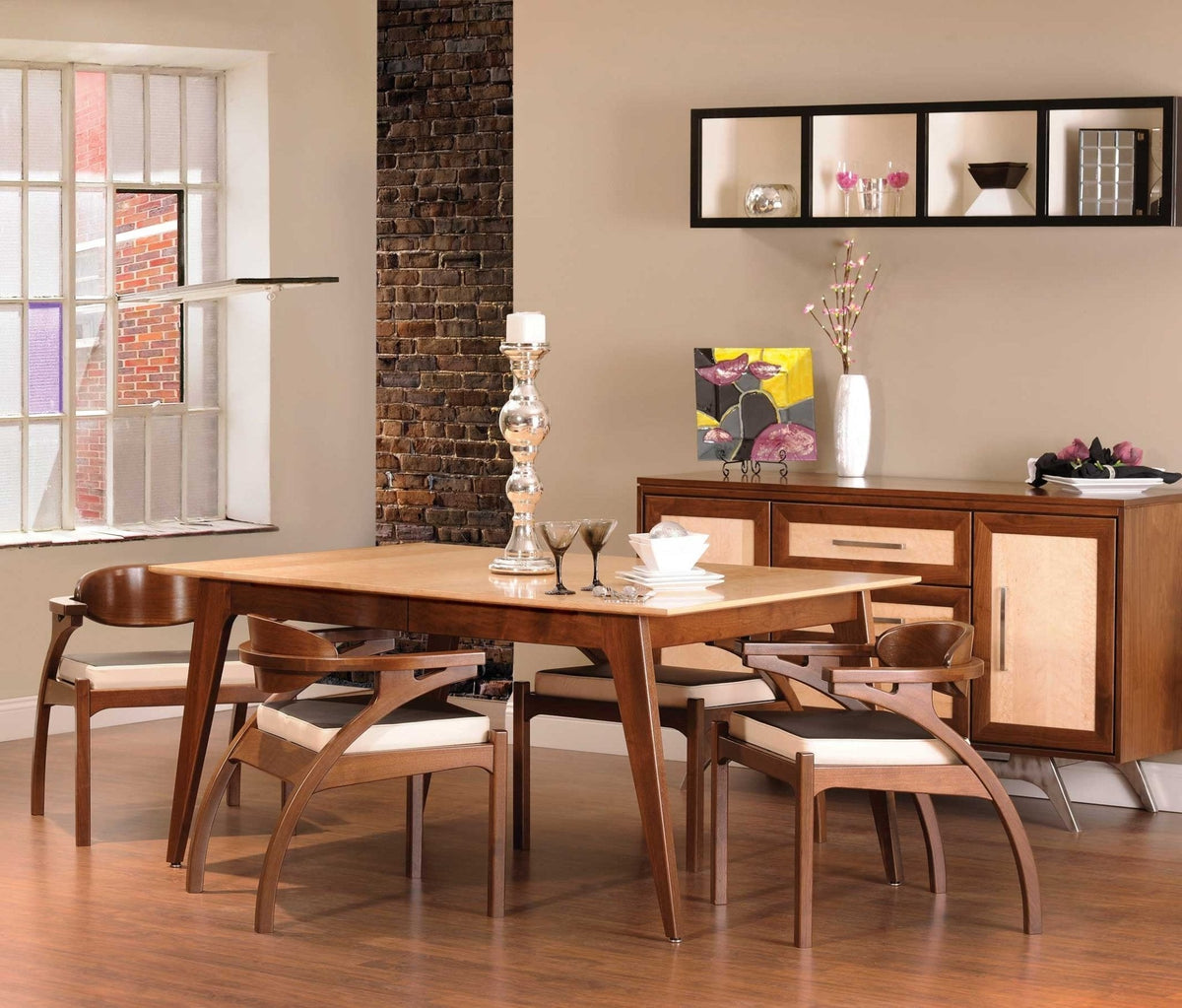 Dining room scene with a two tone mid century modern table, curved wood arm chairs and a matching sideboard
