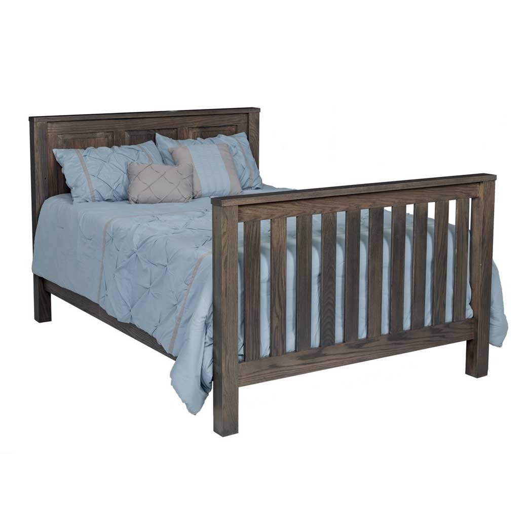 Gray oak crib converted to a full size bed with a raised panel headboard and slatted footboard
