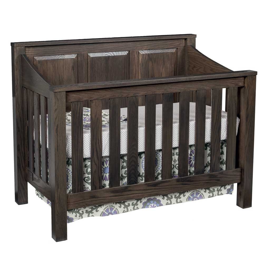 Dark gray stained oak mission crib with three panel headboard, wide slats and floral crib skirt