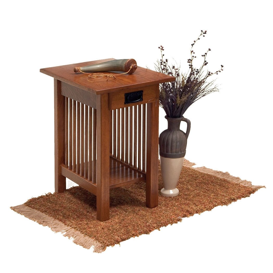 Quartersawn oak chairside end table with drawer, slat sides and bottom shelf styled with a horn and dried floral vase