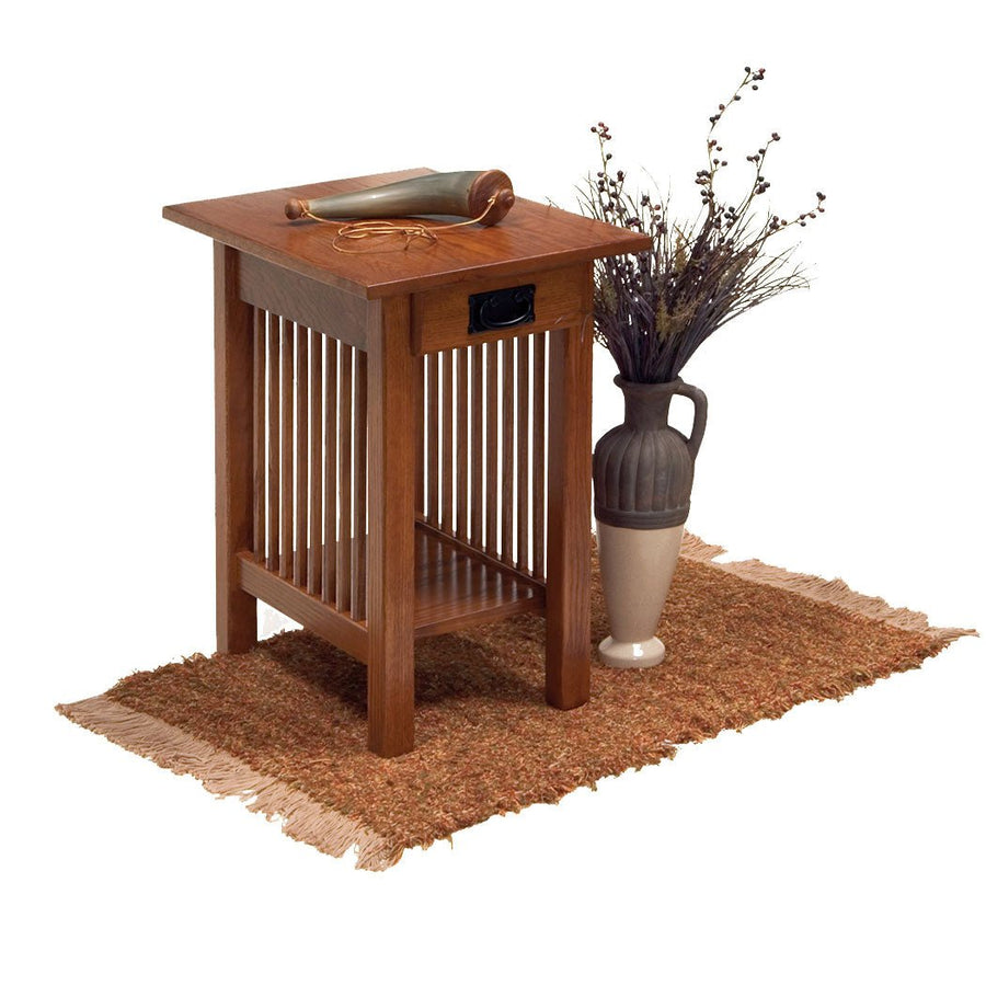 Mission chairside end table in oak with slatted sides, single drawer, lower shelf and a stoneware pitcher alongside