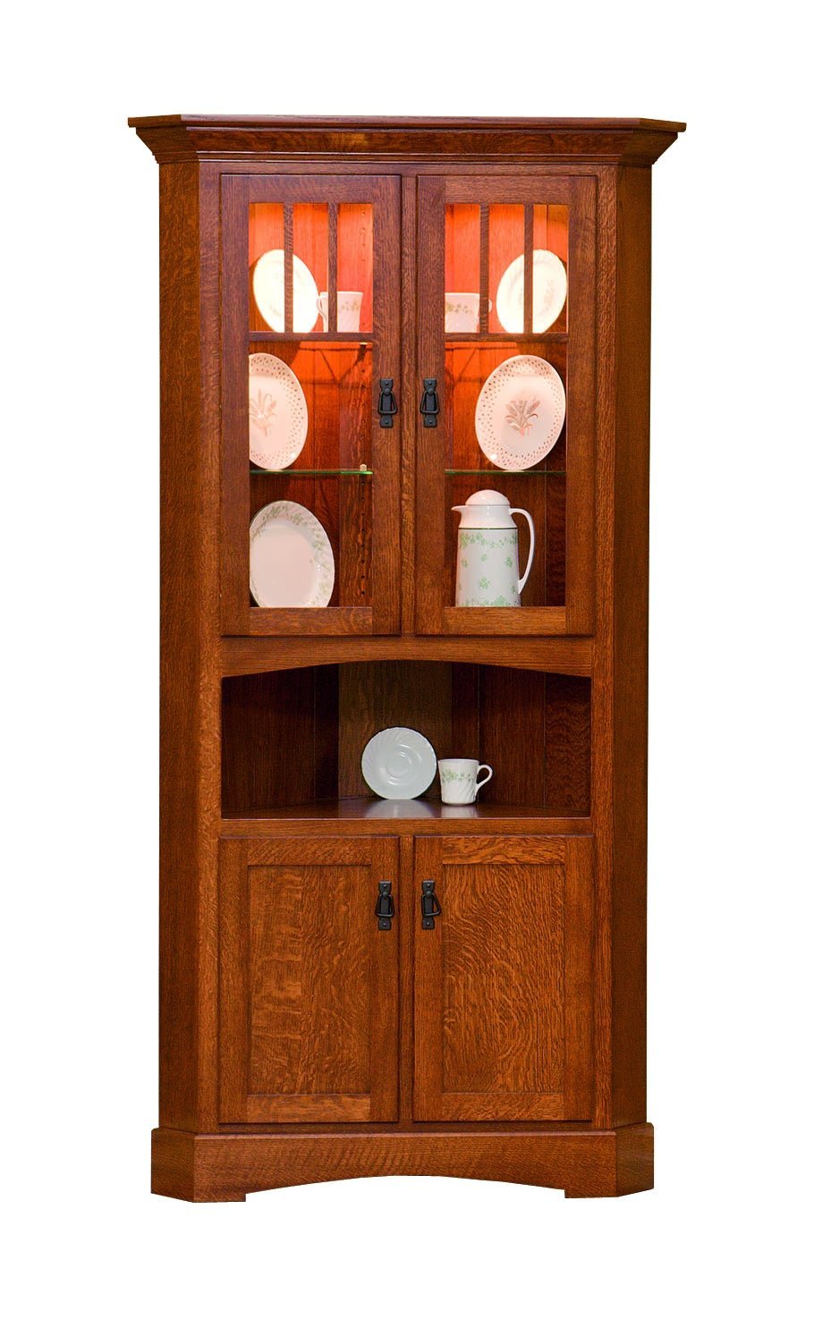 Mission corner cabinet in oak with lighted glass doors displaying plates, an open shelf and paneled base doors