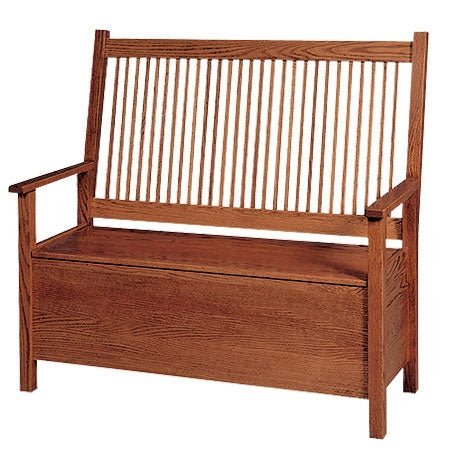 Oak Mission storage bench with spindle back, wide flat arms and paneled sides on a white background