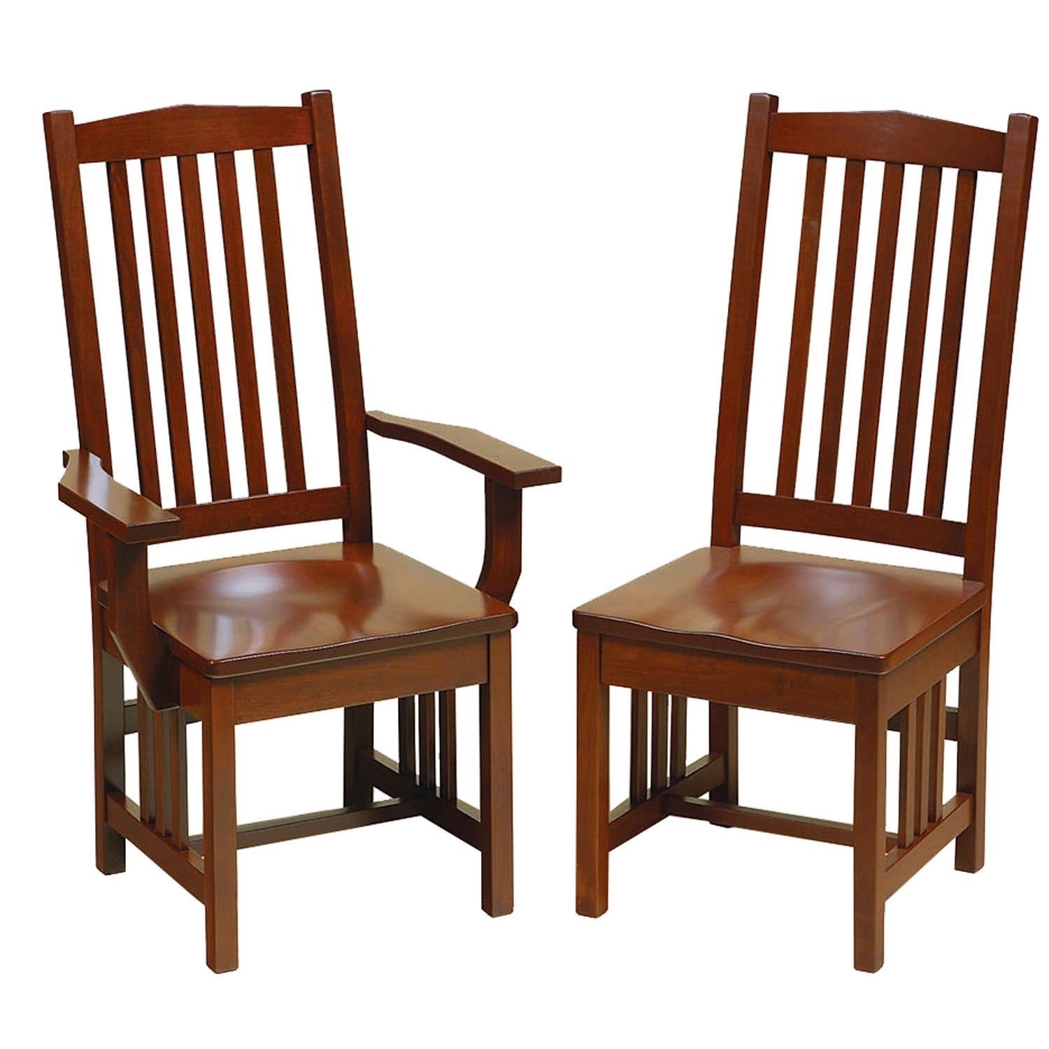 Mission oak dining chairs with vertical slat backs and black leather seats at a trestle table by a hutch