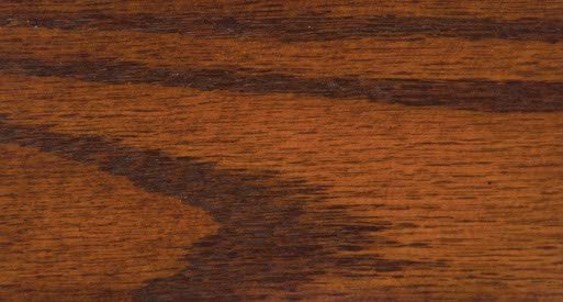 Mission Maple stain on oak sample, an amber brown plank with strong dark cathedral grain figure