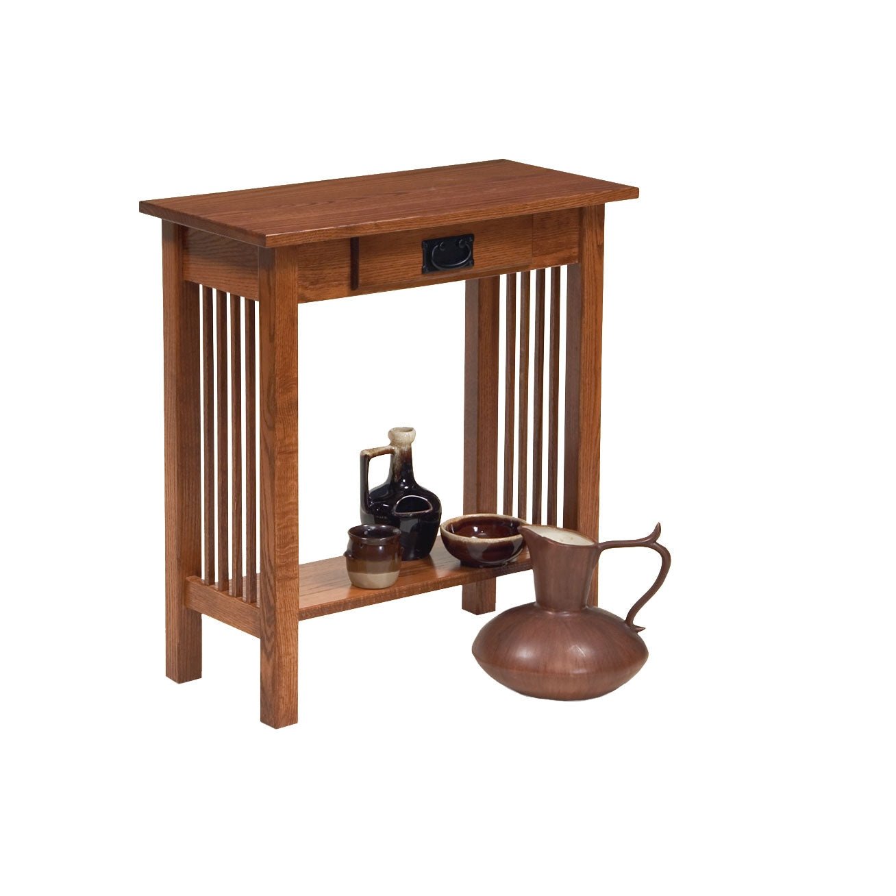 Oak Mission hall table with a drawer and slat sides holding candlesticks, with a topiary on the lower shelf